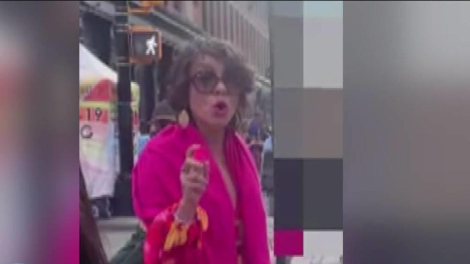 In a screenshot from cell phone video, a woman, identified by police as Madeline Barker, 47, sprays four Asian women with pepper spray in New York City. / Credit: CBS2