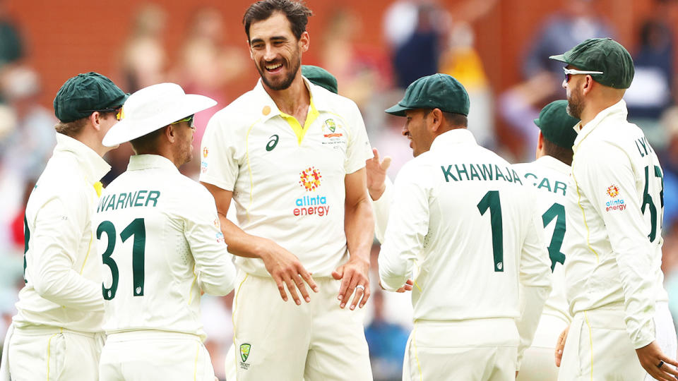 The Australian Test team congregates around fast bowler Mitchell Starc.