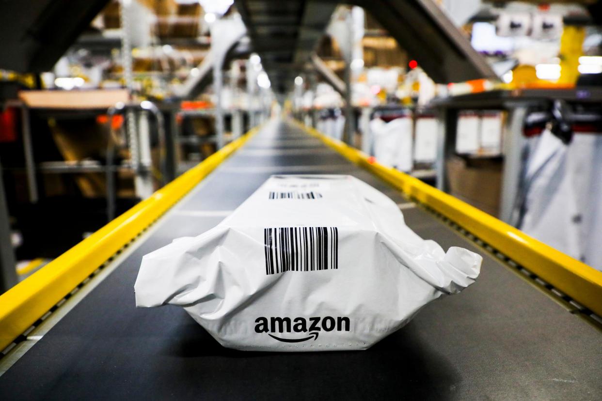 <span>A package on a conveyor belt at an Amazon fulfillment centre in Poland in 2019.</span><span>Photograph: Beata Zawrzel/NurPhoto via Getty Images</span>