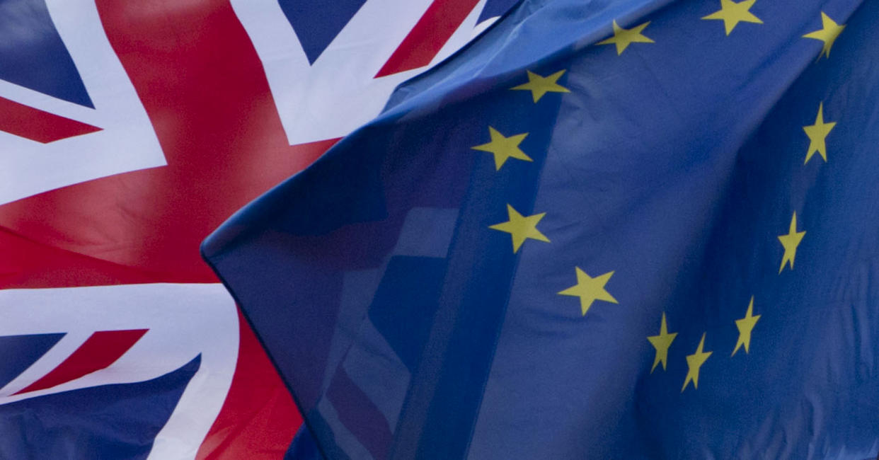 FILE- In this Dec. 8, 2017 file photo, UK's Union Flag, left, and the EU flag, flap in the wind outside EU headquarters in Brussels. On Thursday, Aug. 1, 2019 the European Union has told Britain's new Europe adviser David Frost that it is not prepared to renegotiate the Brexit agreement, three months before the country is due to leave the 28-nation bloc. (AP Photo/Virginia Mayo, File)