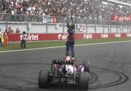 Red Bull Formula One driver Sebastian Vettel of Germany celebrates atop his car after winning the Indian F1 Grand Prix at the Buddh International Circuit in Greater Noida, on the outskirts of New Delhi, October 27, 2013. REUTERS/Adnan Abidi