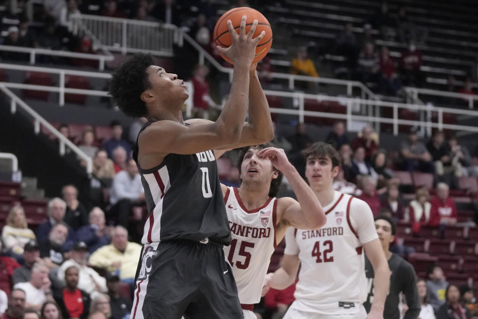 Washington State forward Jaylen Wells (0) shoots against Stanford guard Benny Gealer (15) and forward Maxime Raynaud (42) during the second half of an NCAA college basketball game in Stanford, Calif., Thursday, Jan. 18, 2024. (AP Photo/Jeff Chiu)