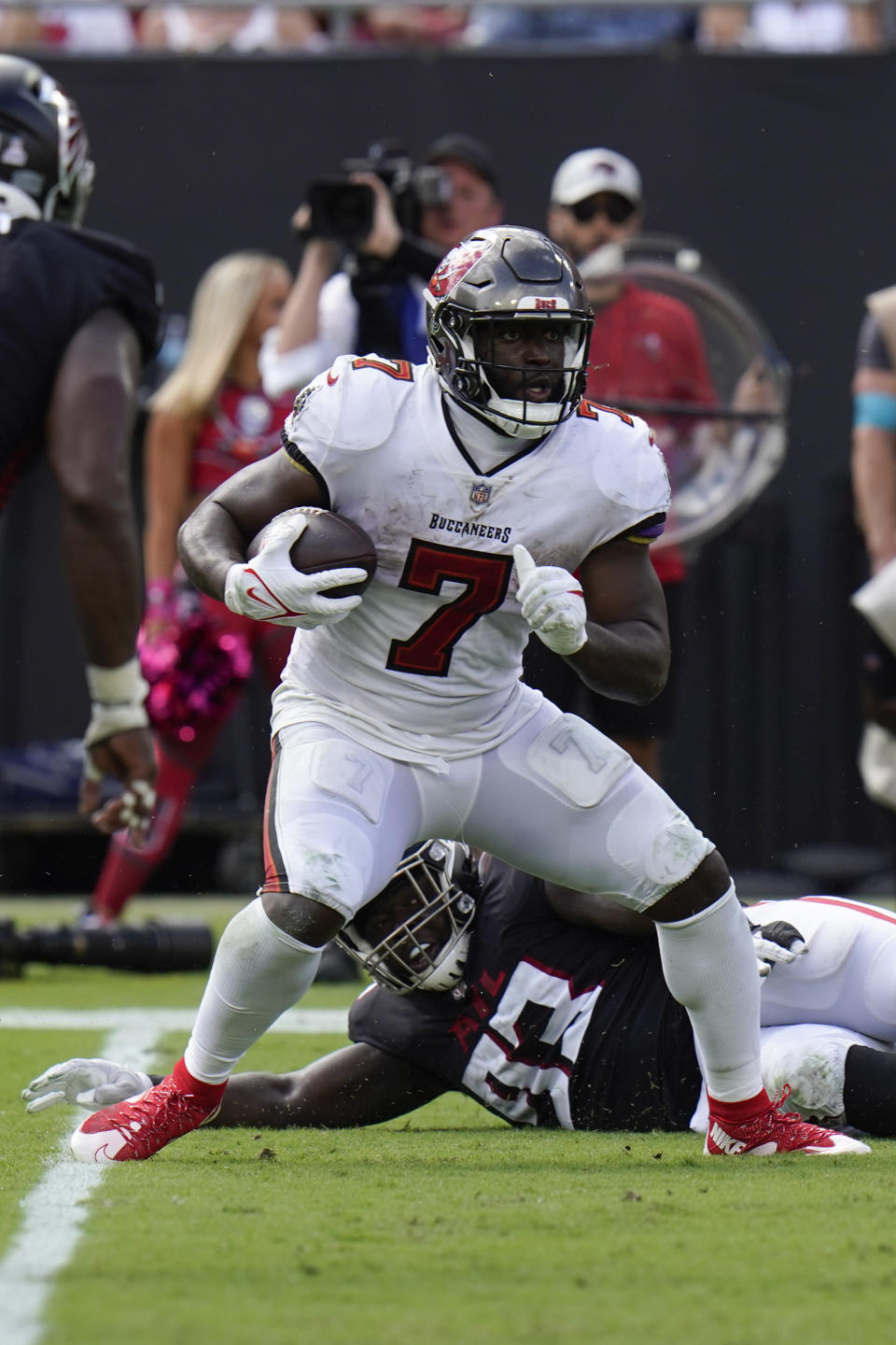 Tampa Bay Buccaneers running back Leonard Fournette (7) is brought down by Atlanta Falcons defensive tackle Timmy Horne (93) during the second half of an NFL football game Sunday, Oct. 9, 2022, in Tampa, Fla. (AP Photo/Chris O'Meara)
