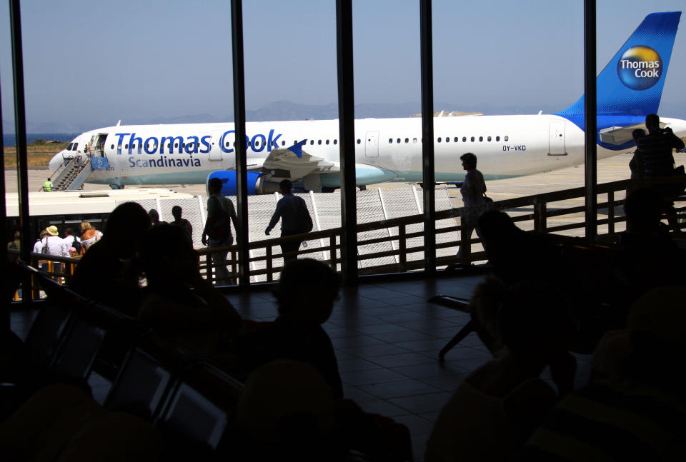 RHODES ISLAND - AUGUST 10:  Passengers wait for boarding on a Thomas Cook Passenger jet at the Airport on August 10, 2008 in Rhodes, Greece. Rhodes is the largest of the greek Dodecanes Islands.  (Photo by EyesWideOpen/Getty Images)