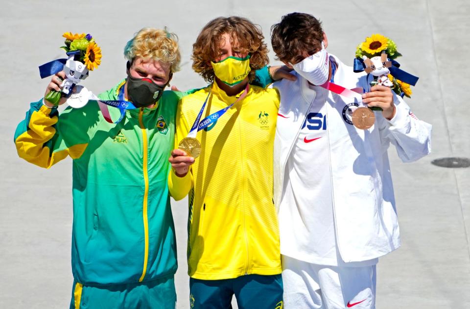 Keegan Palmer celebrates winning the gold medal, Pedro Barros celebrates winning the silver medal and Cory Juneau celebrates winning the bronze medal in the Men's Skateboarding Park during the Tokyo 2020 Olympic Summer Games at Ariake Urban Sports Park.