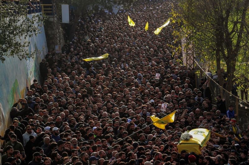 Pro-Iranian Hezbollah supporters carry the coffin of the party top commander Wissam Tawail during his funeral procession in the southern Lebanese village of Khirbit Selem. Tawil is the highest-ranking Hezbollah commander to be killed since the eruption of the cross-border conflict between Israel and Hezbollah in Lebanon on October 8, and the second high-profile assassination to take place in Lebanon in two weeks. Marwan Naamani/dpa