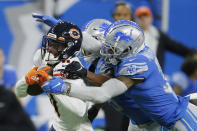 Chicago Bears wide receiver Darnell Mooney (11) is pulled down by Detroit Lions safety Dean Marlowe during the second half of an NFL football game, Thursday, Nov. 25, 2021, in Detroit. (AP Photo/Duane Burleson)