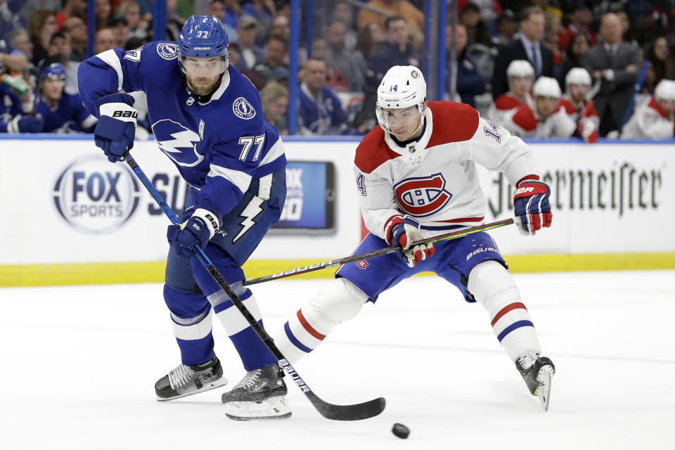 FILE - In this March 5, 2020, file photo, Tampa Bay Lightning defenseman Victor Hedman (77) breaks up a pass intended for Montreal Canadiens center Nick Suzuki (14) during the first period of an NHL hockey game in Tampa, Fla. This is a Stanley Cup matchup for all of those who like their games to be a bit defensive. The Dallas Stars and the Lightning, two of the league's southernmost teams playing for the title in a bubble at the NHL's most northern arena in Edmonton, both have defensemen who provide plenty of points. (AP Photo/Chris O'Meara, File)