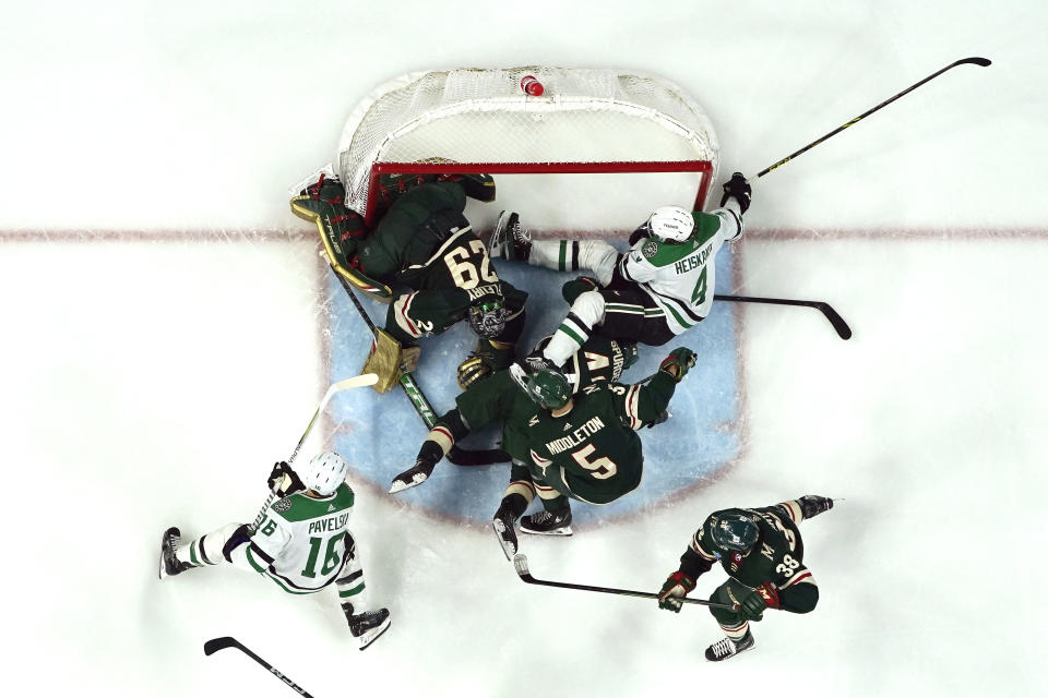 Minnesota Wild goaltender Marc-Andre Fleury (29), left, defends the goal during a pile-up in the third period of an NHL hockey game against the Dallas Stars, Thursday, Dec. 29, 2022, in St. Paul, Minn. (AP Photo/Abbie Parr)