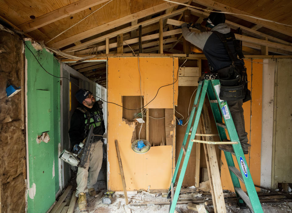 Daniel Zarate, left, works with his brother, Ramiro, on renovating a mobile home for his mother in Bob’s and Jamestown Homeowners Cooperative, a resident-owned mobile home park in Lakewood, Wash., on Saturday, March 25, 2023. When residents learned the park’s owner was looking to sell, they formed a cooperative and bought it themselves amid worries it would be redeveloped. Since becoming owners in September 2022, residents have worked together to manage and maintain the park. (AP Photo/Lindsey Wasson)