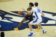 Kennesaw State's Spencer Rodgers, left, dribbles against Creighton's Ryan Kalkbrenner during the first half of an NCAA college basketball game in Omaha, Neb., Friday, Dec. 4, 2020. (AP Photo/Kayla Wolf)