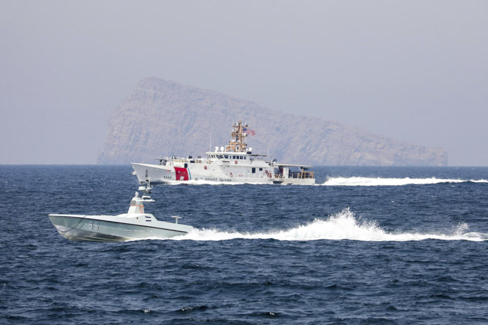 A U.S. Navy L3 Harris Arabian Fox MAST-13 drone boat and the U.S. Coast Guard cutter USCGC John Scheuerman transit the Strait of Hormuz on Wednesday, April 19, 2023. The U.S. Navy sailed its first drone boat through the strategic Strait of Hormuz on Wednesday, a crucial waterway for global energy supplies where American sailors often faces tense encounters with Iranian forces. (Information Systems Technician 1st Class Vincent Aguirre/U.S. Coast Guard via AP)