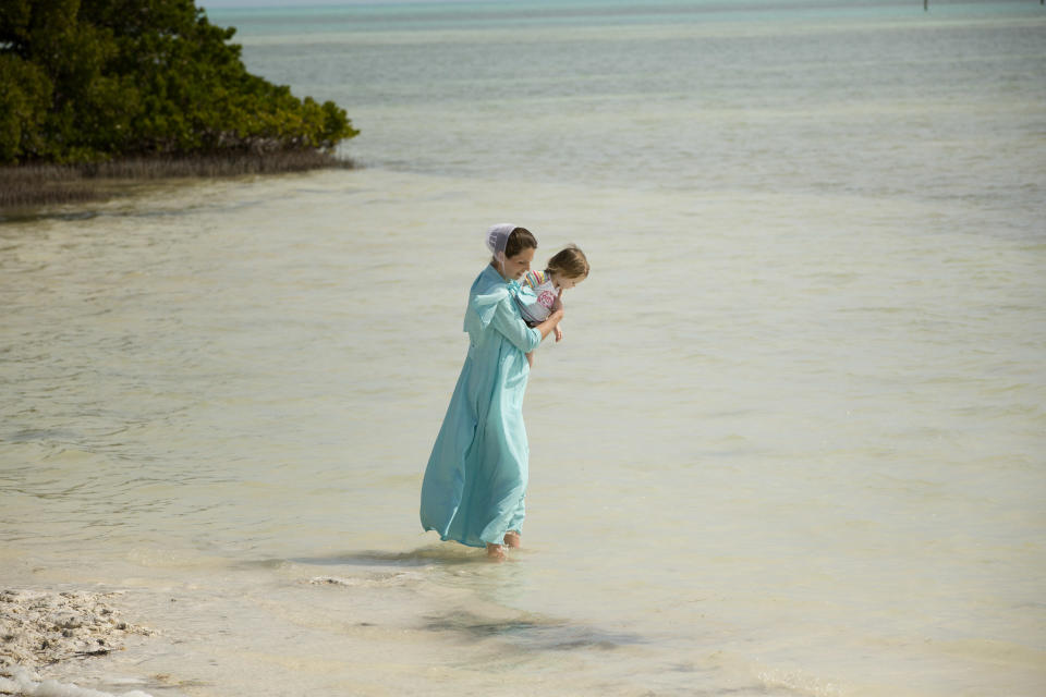 In this Feb. 12, 2013 photo, a visitor and her daughter wade in the waters of Anne's Beach near Islamorada, Fla. The Florida Keys, spanning over 100 miles connected by bridges and causeways, offer plenty of activities at no cost. (AP Photo/J Pat Carter)