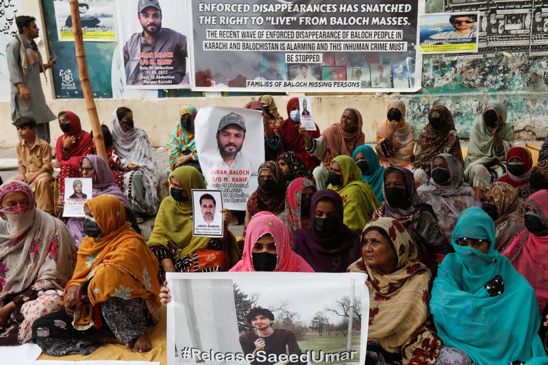 Family members of missing or disappeared persons of the Baloch people hold portraits of their loved ones during a protest in Karachi