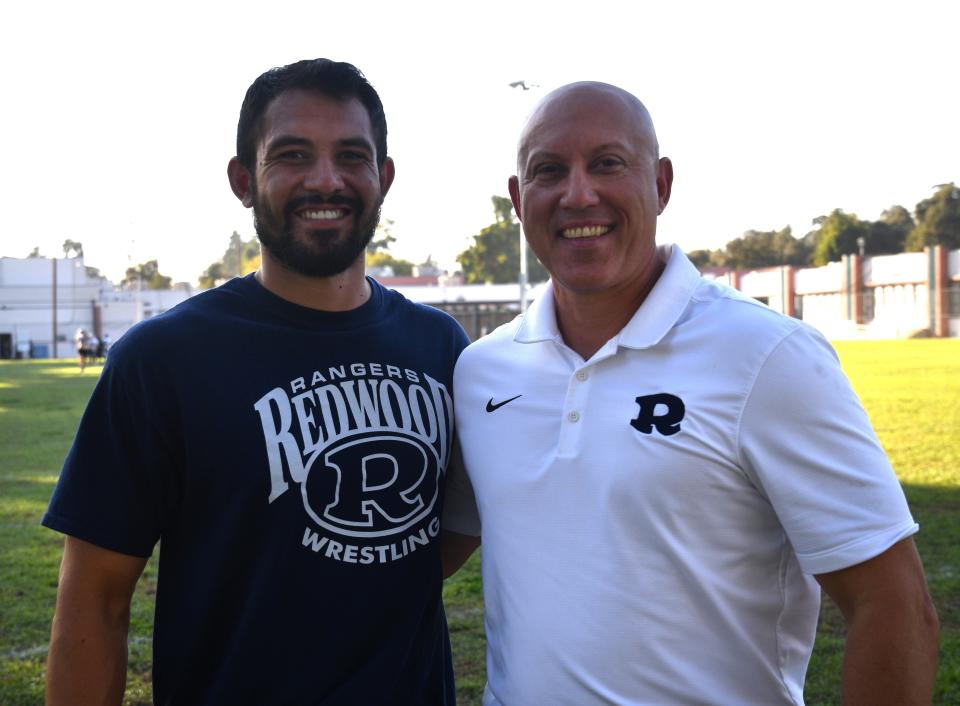 Michael Wright, right, is the athletic director at Redwood High School. His son, Michael II, is a teacher and football and wrestling coach.