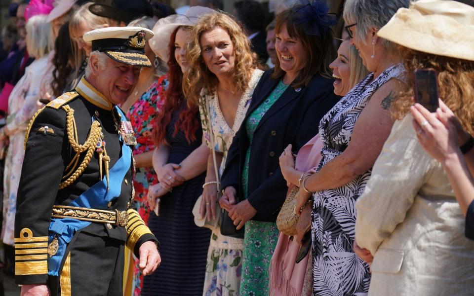 King Charles III talks to relatives after presenting the medals - PA/Jonathan Brady