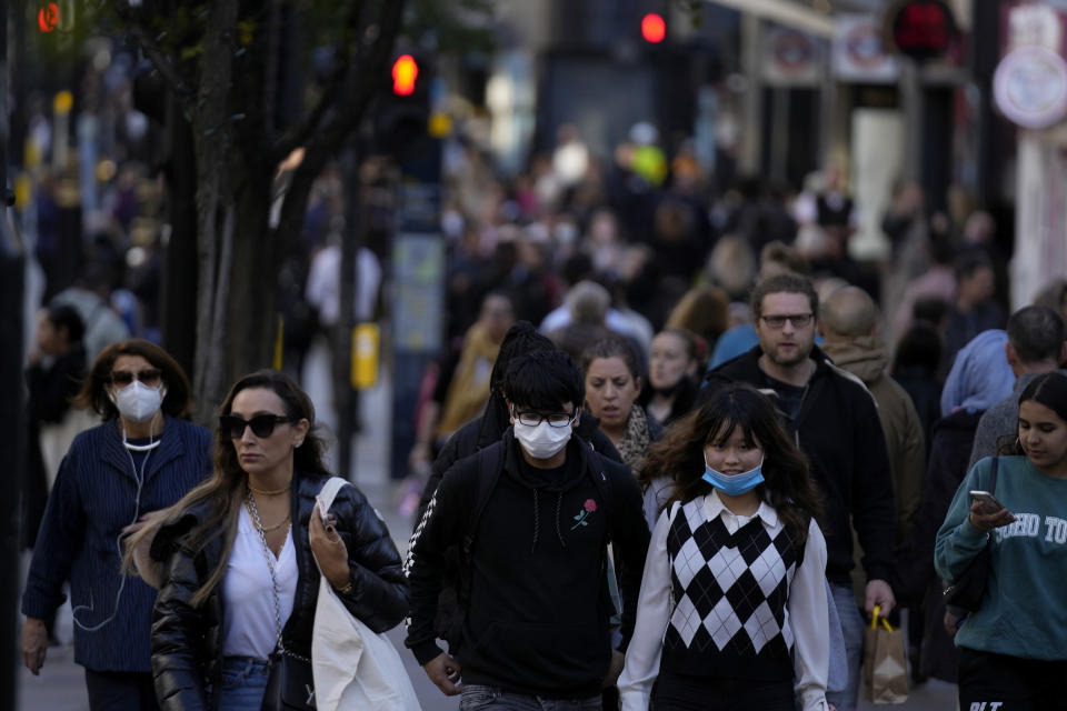 People wearing face masks to curb the spread of coronavirus walk along the Oxford Street shopping area of central London, Wednesday, Oct. 20, 2021. The World Health Organization said there was a 7% rise in new coronavirus cases across Europe last week, the only region in the world where cases increased. Britain, Russia and Turkey accounted for the most cases in Europe. (AP Photo/Matt Dunham)