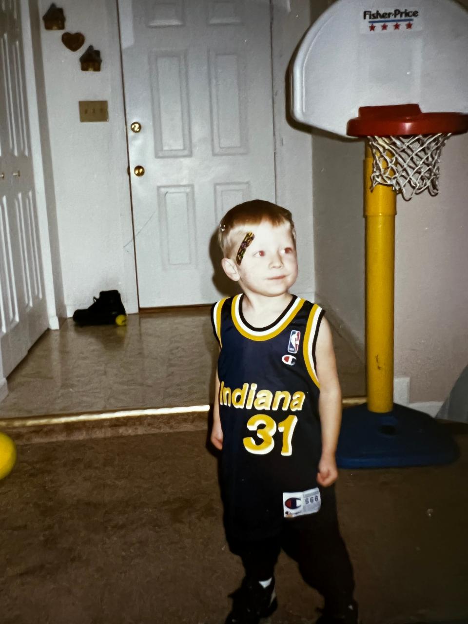 Joey Mulinaro at age 3 pretending to be Reggie Miller, right down to the Band-Aid Miller had to wear.