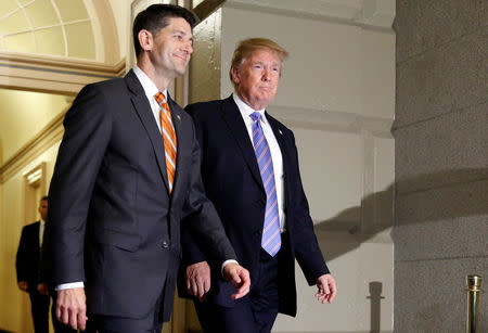 U.S. President Donald Trump walks with Speaker of the House Paul Ryan (R-WI) as they arrive to address a closed House Republican Conference meeting on Capitol Hill, in Washington, U.S., June 19, 2018. REUTERS/Joshua Roberts
