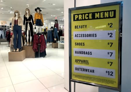 Sales on clothing and shoes are advertised at the entrance to a Forever 21 fashion retail store in downtown Toronto