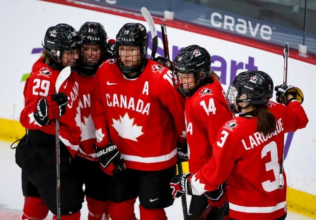 Canada's Renata Fast, centre-left, celebrates her goal with teammates during the first period of a semifinal win over Switzerland in the IIHF women's world championship on Monday in Calgary. (Jeff McIntosh/The Canadian Press - image credit)