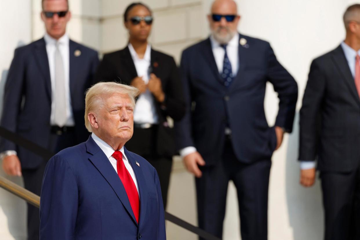 <span>Donald Trump attends wreath laying ceremony at Arlington national cemetery on Monday.</span><span>Photograph: Anna Moneymaker/Getty Images</span>