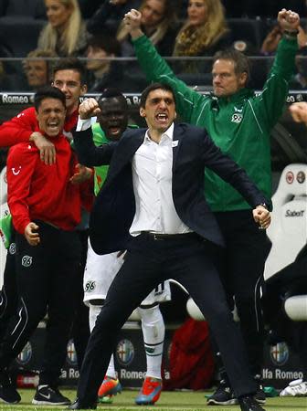 Hanover 96 coach Tayfun Korkut (4th L) reacts after the German first division Bundesliga soccer match against Eintracht Frankfurt in Frankfurt, April 17, 2014. Hanover won the match 3-2. REUTERS/Kai Pfaffenbach