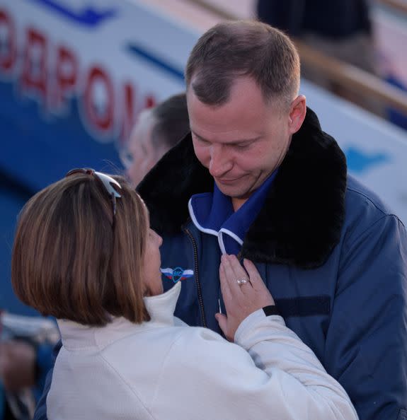 Nick Hague of NASA embraces his wife Catie after landing at the Krayniy Airport.