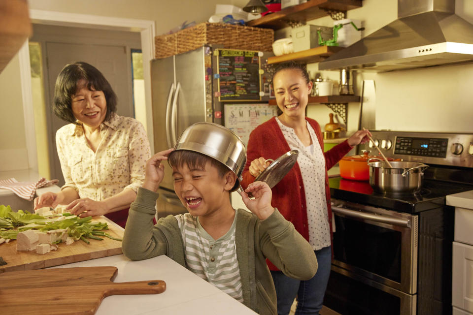 Family enjoy cooking together in a small kitchen