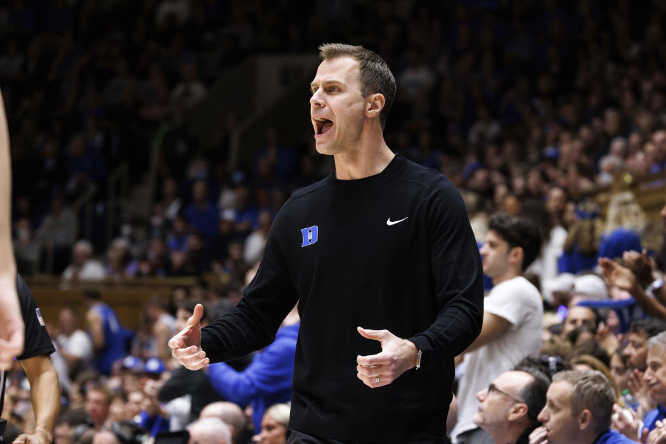 Duke head coach Jon Scheyer shouts towards the court during an NCAA college basketball game against Virginia in Durham, N.C., Saturday, Mar. 2, 2024. (AP Photo/Ben McKeown)