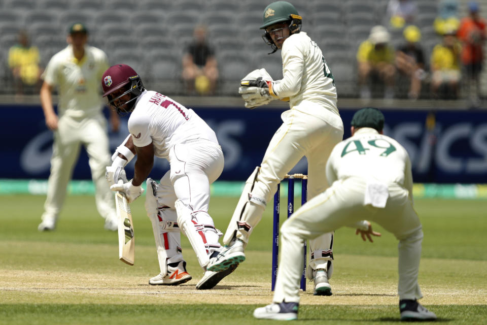 West Indies' Kyle Mayers, left, turns to see he is caught out by Australia's Steve Smith, right, on the 5th day of their cricket test in Perth, Australia, Sunday, Dec. 4, 2022. (AP Photo/Gary Day)