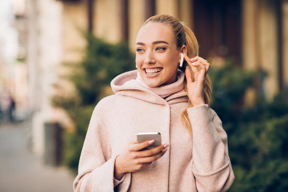 woman with airpods in ear apple