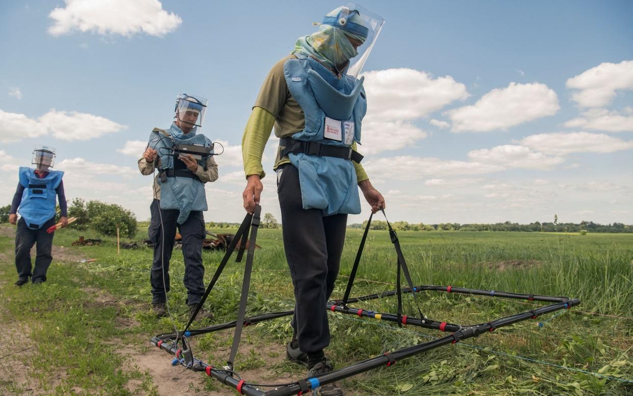 Volunteers from a Danish NGO conduct a search for explosive devices, with the help of an Ebinger large loop metal detector, outside the town of Ichnia, in Chernihiv region, Ukraine on June 7, 2022.  - Vladyslav Musiienko/Reuters