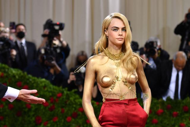 Cara Delevingne shows gold-painted breasts at Met Gala 2022