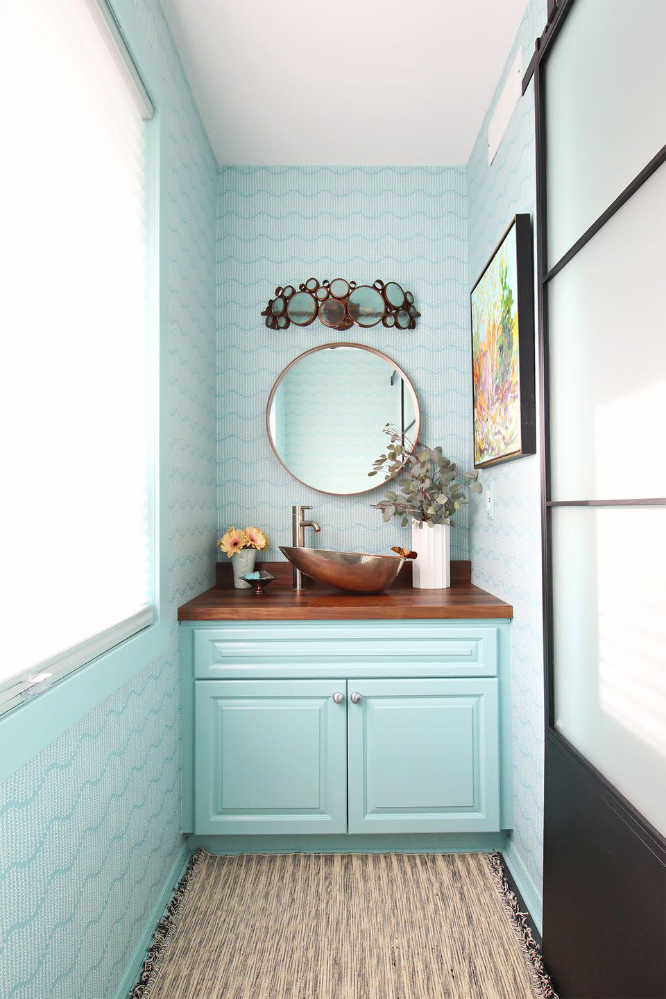 <p>Papering the walls from floor to ceiling gives even the tiniest of rooms extra height. Keep the flow going by painting the cabinets and trim the same color as the wallpaper itself. </p>