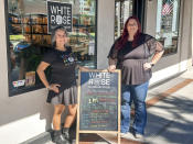 This image released by White Rose Books & More shows bookstore owners Tania Galiñanes, left, and Erin Decker outside their shop in Kissimmee, Fla. on Nov. 4, 2023. (Carlos Galiñanes/White Rose Books & More via AP)