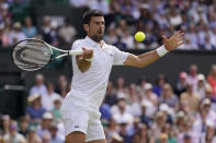 Serbia's Novak Djokovic returns to Poland's Hubert Hurkacz in a men's singles match on day eight of the Wimbledon tennis championships in London, Monday, July 10, 2023. (AP Photo/Alberto Pezzali)