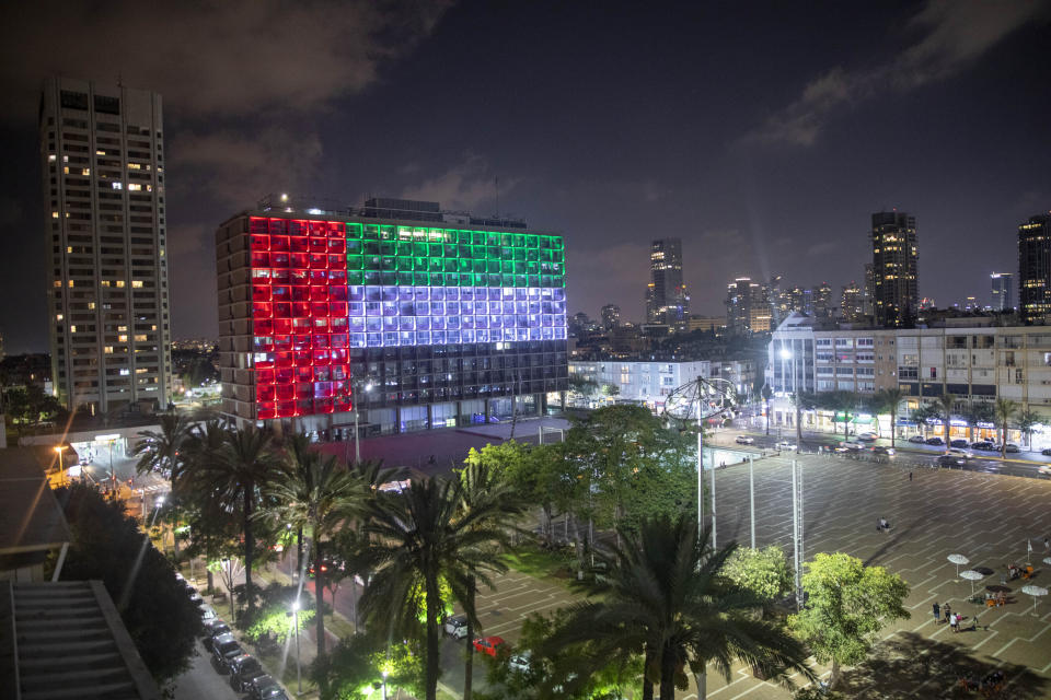 FILE - In this Thursday, Aug. 13, 2020 file photo, the Tel Aviv City Hall is lit up with the flag of the United Arab Emirates as the UAE and Israel announced they would be establishing full diplomatic ties, in Tel Aviv, Israel. On Sunday, Aug. 16, 2020, telephone service between the UAE and Israel began as the two countries opened diplomatic ties. (AP Photo/Oded Balilty, File)