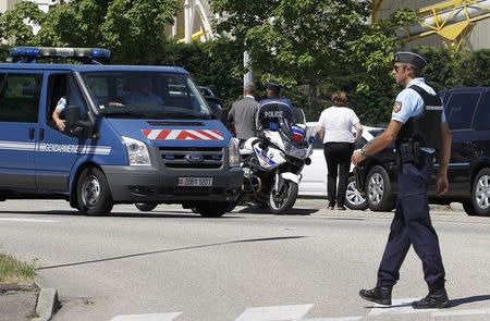 A French Gendarme blocks the access road to the Saint-Quentin-Fallavier industrial area, near Lyon, France, June 26, 2015. REUTERS/Emmanuel Foudrot