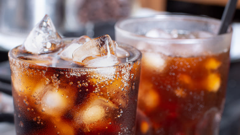 Close-up of caramel-colored soda in two glasses