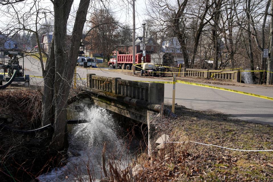 Clean water is pumped into Sulphur Run in East Palestine on Feb. 11.