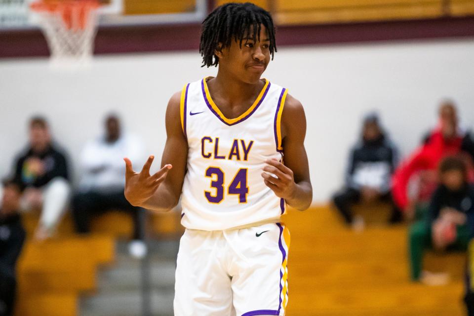 Clay's Tyrese Jones (34) celebrates a 3-point shot during the Clay vs. Marian boys sectional basketball game Tuesday, Feb. 28, 2023 at Jimtown High School in Elkhart.