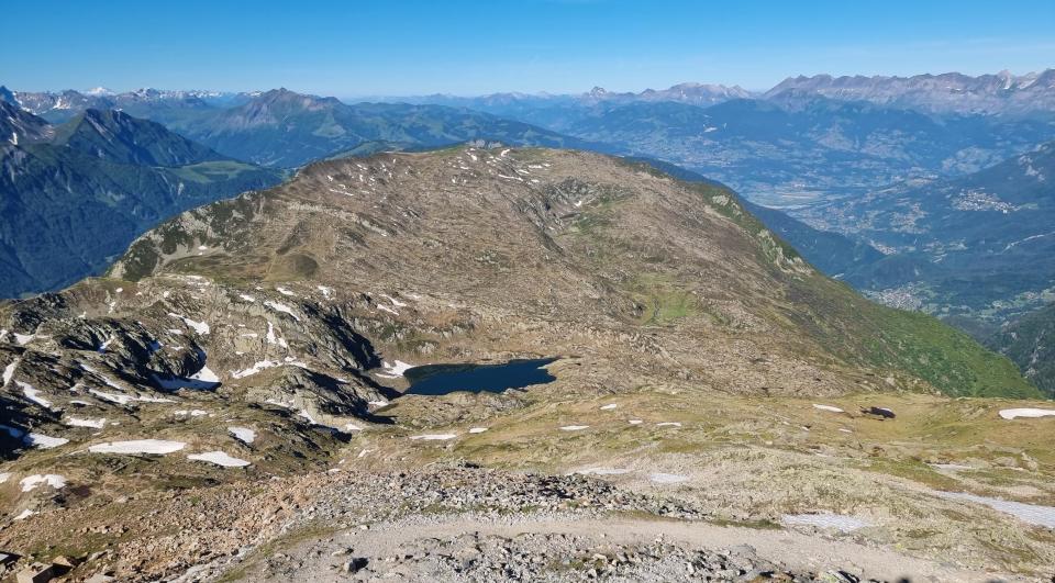 bare mountaintop with small remnants of snow in little crevices