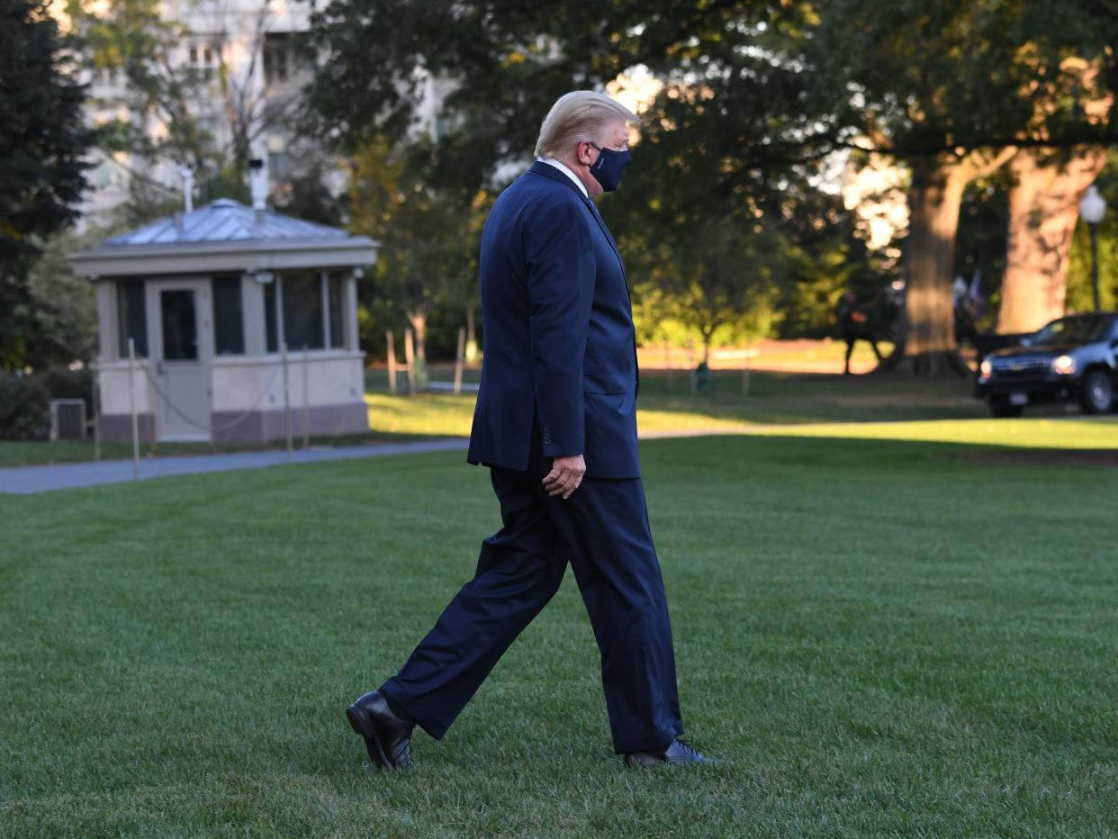 trump white house covid US President Donald Trump walks to Marine One prior to departure from the South Lawn of the White House in Washington, DC, October 2, 2020, as he heads to Walter Reed Military Medical Center, after testing positive for Covid-19. - President Donald Trump will spend the coming days in a military hospital just outside Washington to undergo treatment for the coronavirus, but will continue to work, the White House said Friday (Photo by SAUL LOEB / AFP) (Photo by SAUL LOEB/AFP via Getty Images)