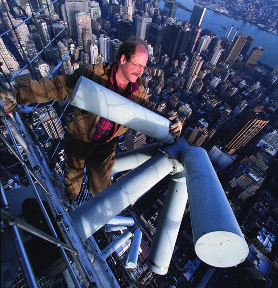 Tom Silliman, president and CEO of Chandler-based of Electronic Research Inc. (ERI), dangles from the top of the Empire State Building while changing a bulb in the aviation beacon in the undated photo. ERI is marking its 80th anniversary this year.