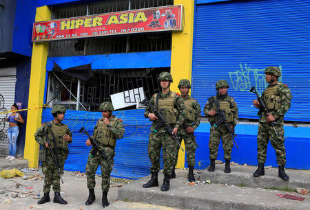 Colombian soldiers guard a supermarket supposedly linked to FARC in Bogota, Colombia February 21, 2018. REUTERS/Jaime Saldarriaga