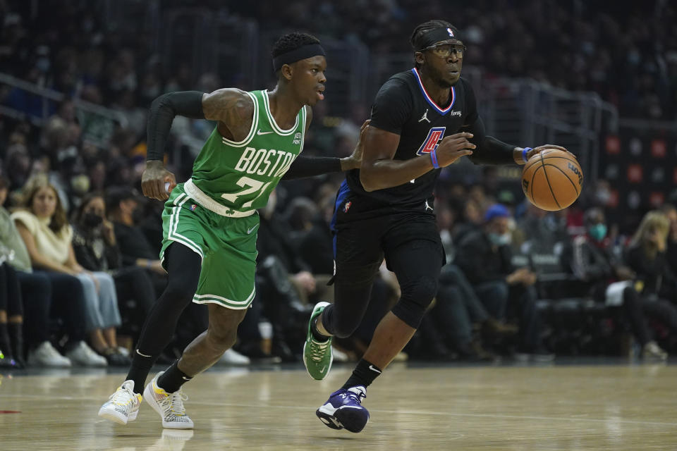 Boston Celtics guard Dennis Schroder (71) defends agains tLos Angeles Clippers guard Reggie Jackson (1) during the first half of an NBA basketball game in Los Angeles, Wednesday, Dec. 8, 2021. (AP Photo/Ashley Landis)