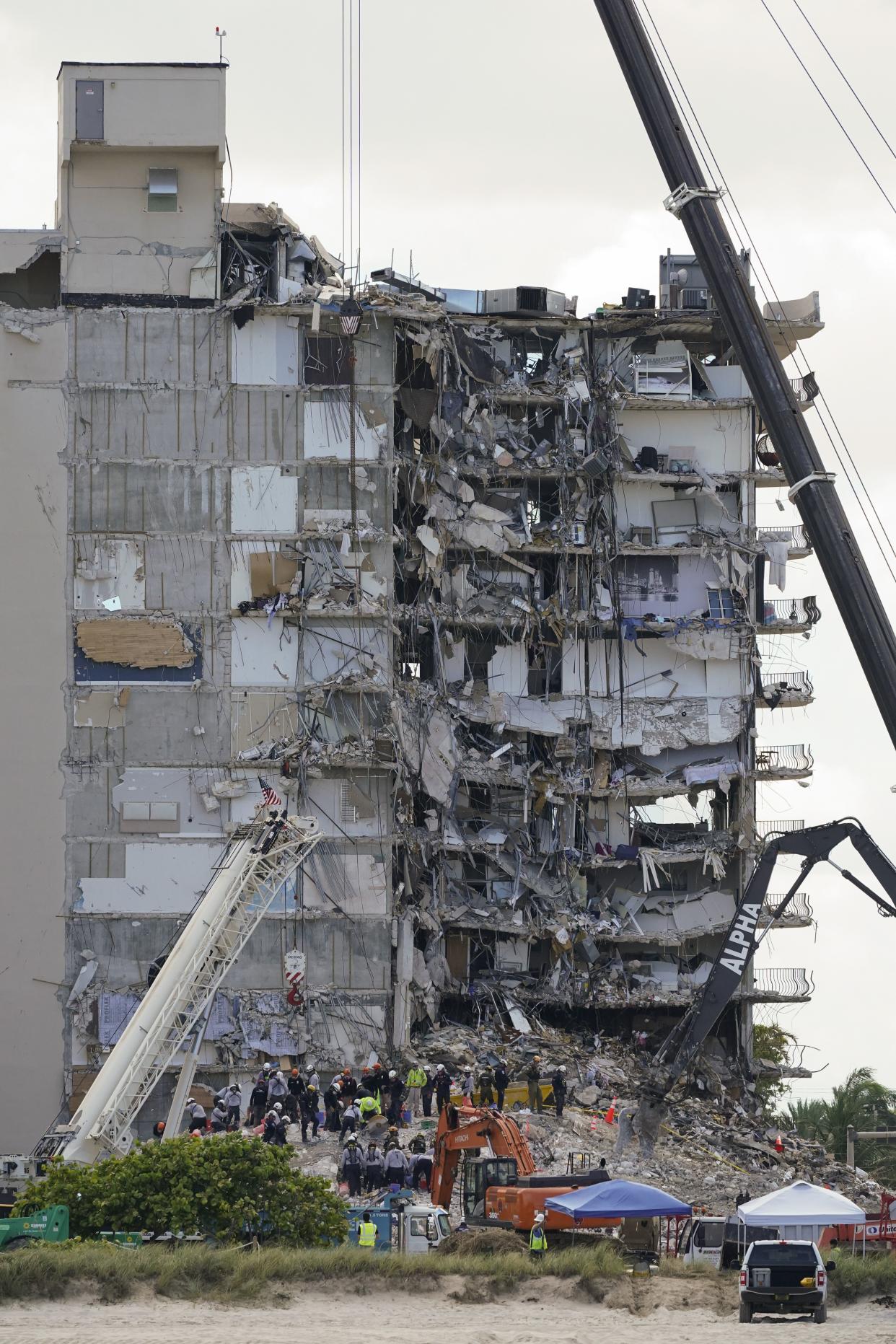 Search and rescue personnel work atop the rubble at the Champlain Towers South condo building, where scores of victims remain missing more than a week after it partially collapsed, Friday, July 2, 2021, in Surfside, Fla.