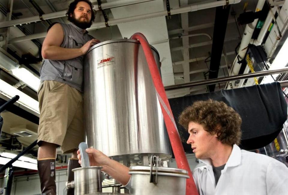 Masters student Thomas Clawson, left, and NCSU PhD graduate student and assistant research brewer Brandon Jones, right, work on a batch of Chancellor’s Choice IPA (India Pale Ale) in the Brewery in the Pilot Plant on the school’s campus in Raleigh, N.C. on Thursday, July 23, 2015.