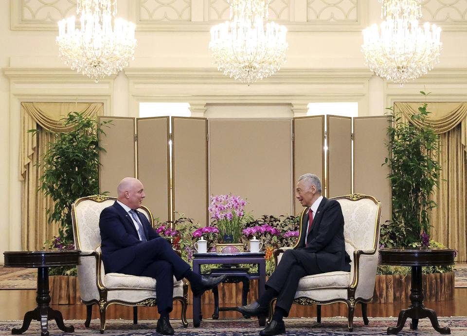 In this photo released by Singapore's Ministry of Communications and Information, New Zealand Prime Minister Luxon, left, chats with Singapore's Prime Minister Lee Hsien Loong at the Istana, Monday, April 15, 2024. (Terence Tan/Ministry of Communications and Information via AP)